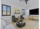 Inviting living room with neutral decor, contemporary furnishings, a ceiling fan, and a large television screen at 19702 E Melissa Pl, Queen Creek, AZ 85142