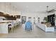 Spacious living room with seamless kitchen access, featuring an open layout, and a large window at 19702 E Melissa Pl, Queen Creek, AZ 85142