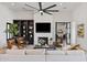 Inviting living area showcases a fireplace, built-in shelving, a modern ceiling fan, and plush furnishings at 19702 E Melissa Pl, Queen Creek, AZ 85142