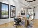 Bright office featuring a contemporary wooden desk, comfortable seating, and modern lighting with backyard views at 19702 E Melissa Pl, Queen Creek, AZ 85142