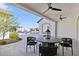 Outdoor patio with a dining table, views of the pool, and lush landscaping, ideal for entertaining at 19702 E Melissa Pl, Queen Creek, AZ 85142
