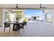 Covered patio with a dining area, ceiling fans, and views of the pool and outdoor living space at 19702 E Melissa Pl, Queen Creek, AZ 85142