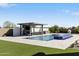 Inviting pool area with a covered outdoor kitchen, comfortable lounge seating, and manicured landscaping at 19702 E Melissa Pl, Queen Creek, AZ 85142