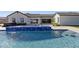 A luxurious swimming pool with an elevated spa, a modern pool house, and a private backyard at 19702 E Melissa Pl, Queen Creek, AZ 85142