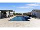 Sparkling pool with an adjacent lounge seating, manicured lawn, and a lush landscape at 19702 E Melissa Pl, Queen Creek, AZ 85142