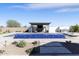 Beautiful swimming pool with a tanning ledge, outdoor kitchen, and a cozy seating area at 19702 E Melissa Pl, Queen Creek, AZ 85142
