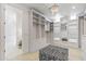 Spacious walk-in closet featuring custom shelving, drawers, mirrored cabinets and a plush zebra-striped ottoman at 19702 E Melissa Pl, Queen Creek, AZ 85142