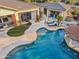 Aerial view showcasing a large house, expansive pool, and lush landscaping at 27432 N 66Th Way, Scottsdale, AZ 85266