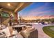 Relaxing backyard patio with firepit and comfortable seating, overlooking a stunning pool and desert landscape at 27432 N 66Th Way, Scottsdale, AZ 85266