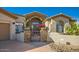 Inviting entryway with stone accents and a modern metal gate at 27432 N 66Th Way, Scottsdale, AZ 85266