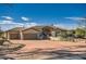 Beautiful home exterior with three-car garage and desert landscaping at 27432 N 66Th Way, Scottsdale, AZ 85266