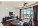 Gathering room with a large TV, hardwood floors, and sliding doors to backyard oasis at 27432 N 66Th Way, Scottsdale, AZ 85266