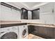 Bright laundry room, featuring washer, dryer, and ample cabinetry at 27432 N 66Th Way, Scottsdale, AZ 85266