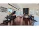 Bright living room with a grand piano, hardwood floors, and large windows at 27432 N 66Th Way, Scottsdale, AZ 85266
