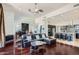 Open living space with a leather sectional, modern kitchen, and hardwood floors at 27432 N 66Th Way, Scottsdale, AZ 85266