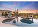 Stunning pool and spa with a unique design, surrounded by desert landscaping at 27432 N 66Th Way, Scottsdale, AZ 85266