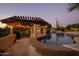Evening view of a refreshing pool and a pergola with string lights at 27432 N 66Th Way, Scottsdale, AZ 85266