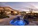 Luxurious spa with blue lighting nestled in a beautifully landscaped backyard at 27432 N 66Th Way, Scottsdale, AZ 85266