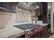Modern gas cooktop with custom cabinetry and backsplash at 5800 E Glen Dr, Paradise Valley, AZ 85253