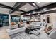 Spacious living room with a curved sectional sofa, fireplace, and stunning mountain views at 5800 E Glen Dr, Paradise Valley, AZ 85253