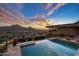 Infinity pool with sunset views and mountain backdrop at 5800 E Glen Dr, Paradise Valley, AZ 85253