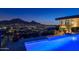 Night view of a pool with city lights and mountains at 5800 E Glen Dr, Paradise Valley, AZ 85253