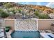 Waterfall feature in a beautiful backyard pool area at 5800 E Glen Dr, Paradise Valley, AZ 85253