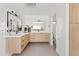 Modern bathroom with light wood cabinets and marble at 6733 N 14Th St, Phoenix, AZ 85014