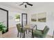 Modern home office with glass desk, green chairs, and wood floors at 6733 N 14Th St, Phoenix, AZ 85014