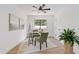 Bright home office features glass desk, green chairs, and wood floors at 6733 N 14Th St, Phoenix, AZ 85014