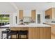 Modern kitchen with marble countertops and light wood cabinets at 6733 N 14Th St, Phoenix, AZ 85014