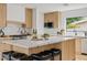 Modern kitchen with light wood cabinets and large island with seating at 6733 N 14Th St, Phoenix, AZ 85014