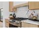 Modern kitchen with stainless steel range and marble backsplash at 6733 N 14Th St, Phoenix, AZ 85014