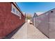 Brick pathway alongside the home leads to a side yard at 7109 E Plata Ave, Mesa, AZ 85212