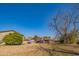 Spacious backyard with mature trees and a view of the home at 10407 W Catalina Dr, Avondale, AZ 85392