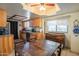 Eat-in kitchen with wood cabinets, granite counters, and a view to the dining area at 10407 W Catalina Dr, Avondale, AZ 85392