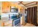 Bright kitchen features granite countertops, wood cabinets, and modern appliances at 10407 W Catalina Dr, Avondale, AZ 85392