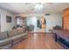 Open living area features hardwood floors, a view into the kitchen, and a pool table at 10407 W Catalina Dr, Avondale, AZ 85392