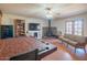 Cozy living room with wood burning stove, hardwood floors, and vintage furniture at 10407 W Catalina Dr, Avondale, AZ 85392