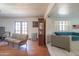 Spacious living room with hardwood floors, a wood burning stove, and French doors at 10407 W Catalina Dr, Avondale, AZ 85392