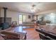 Open living area with hardwood floors, a fireplace, and built-in shelving at 10407 W Catalina Dr, Avondale, AZ 85392