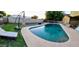 Inviting backyard pool perfect for cooling off on a hot day with poolside lounging and a lush green lawn at 10407 W Catalina Dr, Avondale, AZ 85392