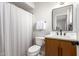 Clean bathroom with a modern vanity, white toilet, and shower/tub combo at 1102 W Lindner Ave, Mesa, AZ 85210