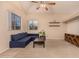 Living room with a blue sectional sofa and built-in shelves at 1410 E Dunbar Dr, Phoenix, AZ 85042