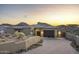 Beautiful desert home featuring a modern garage door, xeriscaping, tile roof and mountain views at 14828 E Valley Vista Dr, Fountain Hills, AZ 85268