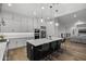 Open-concept kitchen featuring an island with seating, modern appliances, and hardwood flooring at 14828 E Valley Vista Dr, Fountain Hills, AZ 85268