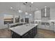 Modern kitchen with a large island, pendant lighting, and stainless steel appliances, open to the dining area at 14828 E Valley Vista Dr, Fountain Hills, AZ 85268