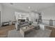 Cozy living room with an oversized sectional, hardwood floors, and an open layout leading to the kitchen and dining area at 14828 E Valley Vista Dr, Fountain Hills, AZ 85268