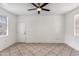 Spacious bedroom with tile floors and ceiling fan at 16657 S 21St St, Phoenix, AZ 85048