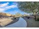 Curving concrete pathway through a landscaped community area at 18280 W Sells Dr, Goodyear, AZ 85395